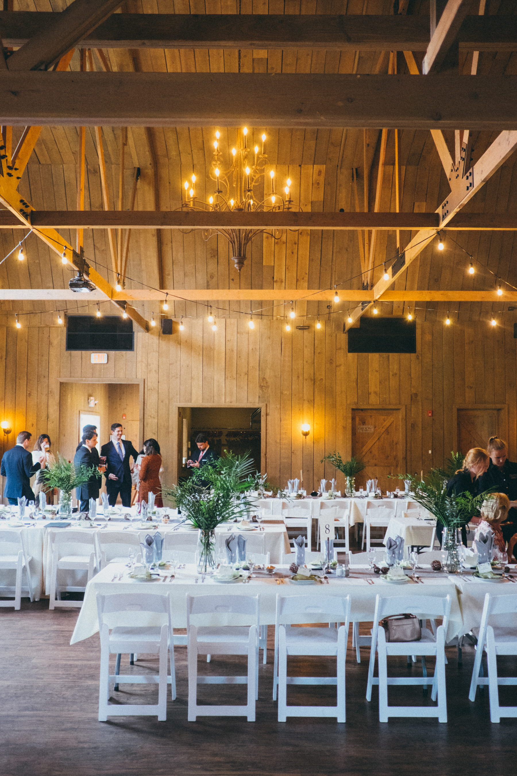 Tables set for a wedding inside Rustic Manor 1848