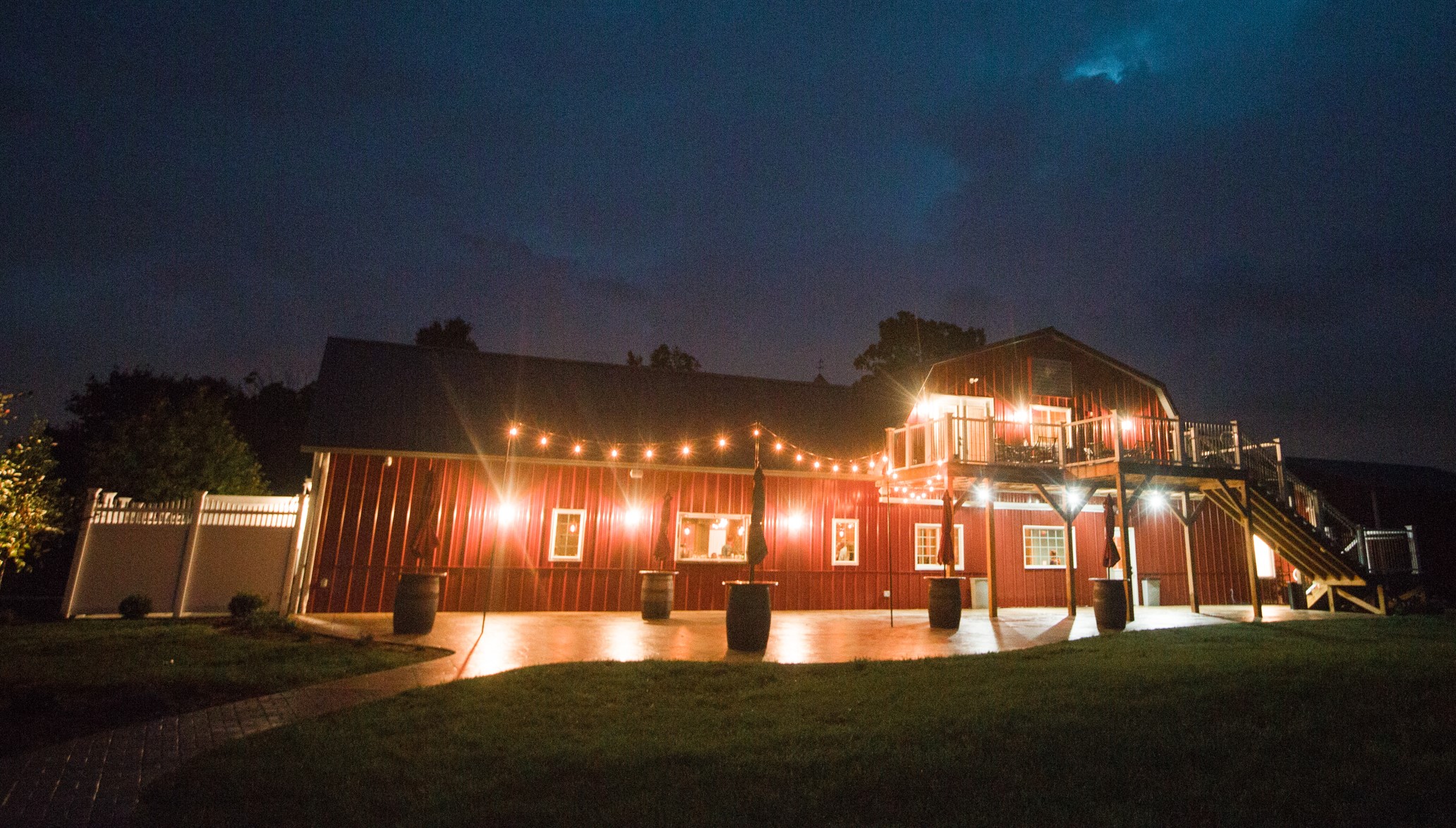 Rustic Manor with white lights at night.