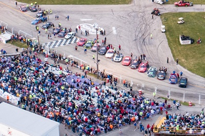 Aerial drone view of race cars lined up at Slinger Speedway by QC Willy.