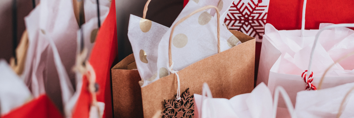 A photo of Christmas gift bags all lined up.